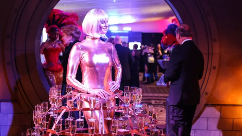 Contemporary Productions event with woman in a dress made out of champagne glasses