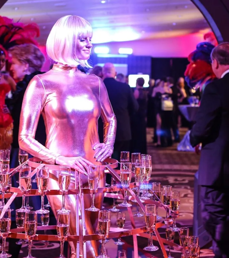 Contemporary Productions event with woman in a dress made out of champagne glasses