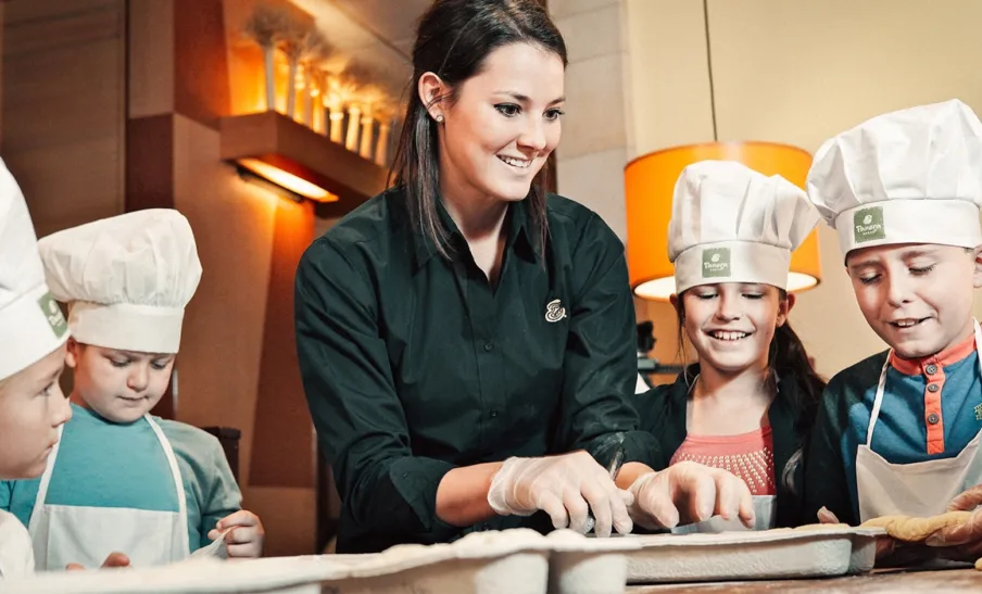 Panera Bread Bakers-in-Training teacher and students in chefs hats
