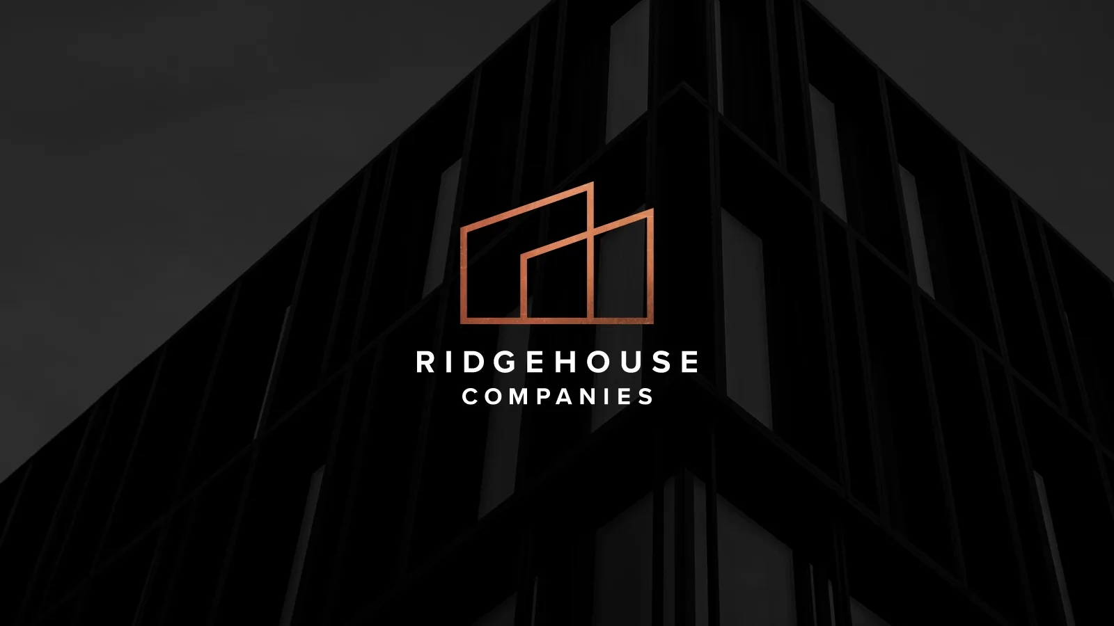 Ridgehouse Logo centered atop a silhouette of a tall building