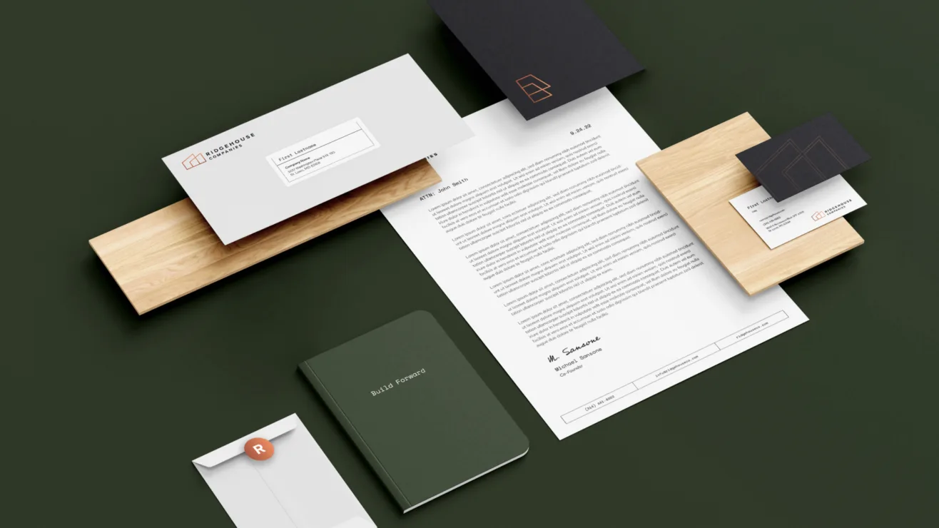 A branded corporate stationery set including an envelope, letterhead, dark green notebook, and business cards on a dark green background.