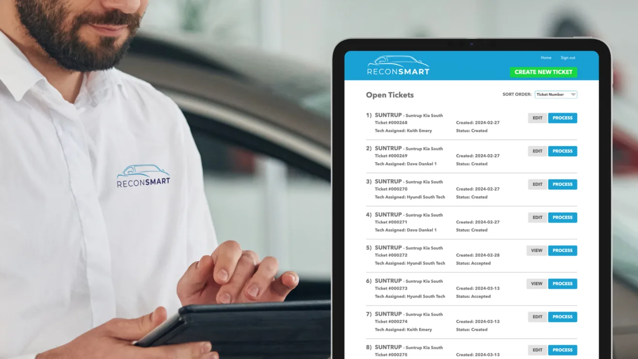 A technician in a branded ReconSmart shirt using a tablet to process open service tickets.